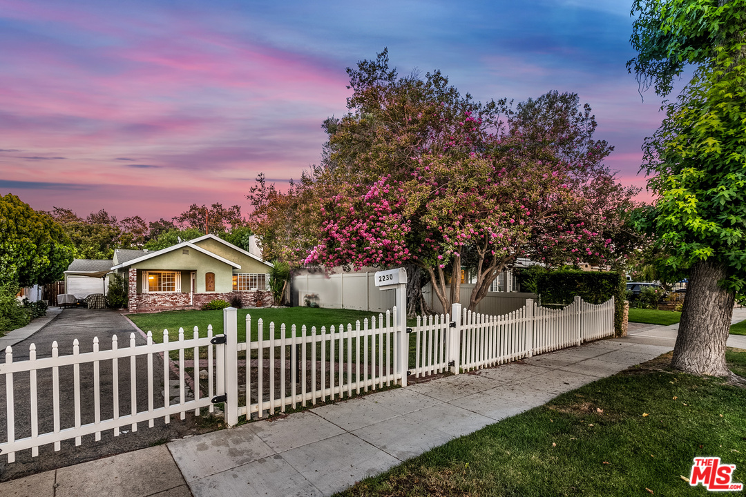 2230 N Lamer St Burbank, California This gorgeous home in a lovely Burbank neighborhood is move-in ready! The front entry immediately strikes awe with its brick exteriors, lush front yard, and a decorative stained glass window. Step inside to vaulted ceilings, lots of great natural light, and beautifully cared-for features throughout. The kitchen has charming green and white tile counters and a peek-through window into the dining and living areas. The Master bedroom opens to the private, fenced-in backyard and the attached bathroom has attractive, updated features including a step-up shower/tub. With a fenced-in front and back yard, this property is great for entertaining and to retreat and enjoy one's home.