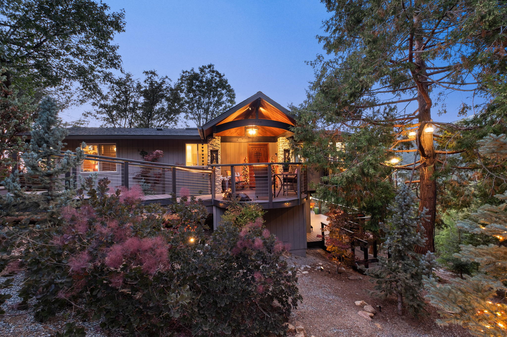Fully remodeled and upgraded, this stunning Mid-Century Modern masterpiece retains its 1962 heritage while seamlessly incorporating today's preferred amenities. Built into the mountainside on a quiet cul-de-sac in Idyllwild, the home is poised to enjoy 180-degree views that span lush forests, Lily Rock and majestic mountains that soar as high as 10,000 feet. Surrounded by natural boulders, Japanese maples and blue spruce trees, the two-level showplace is embraced by 5 decks that encompass about 1,383 s.f. of outdoor living space and is protected by owner-owned vacant lot. Vaulted and beamed knotty pine ceilings and floor-to-ceiling windows emphasize the home's coveted Mid-Century style, while high-end wood-style laminate flooring, custom lighting fixtures, custom millwork, plantation shutters and lighted art niches are showcased. Approx. 1,762 s.f., the 3-bedroom, 2 full baths and powder room residence features a great room, office or fourth bedroom, solarium nook, a lower-level ensuite with deck, and a chef-caliber kitchen. Select furnishings available.  House only,  $1,095,000.  Separately, an .18 acre adjacent street front view lot is being offered for $85,000 to protect home's view and privacy.