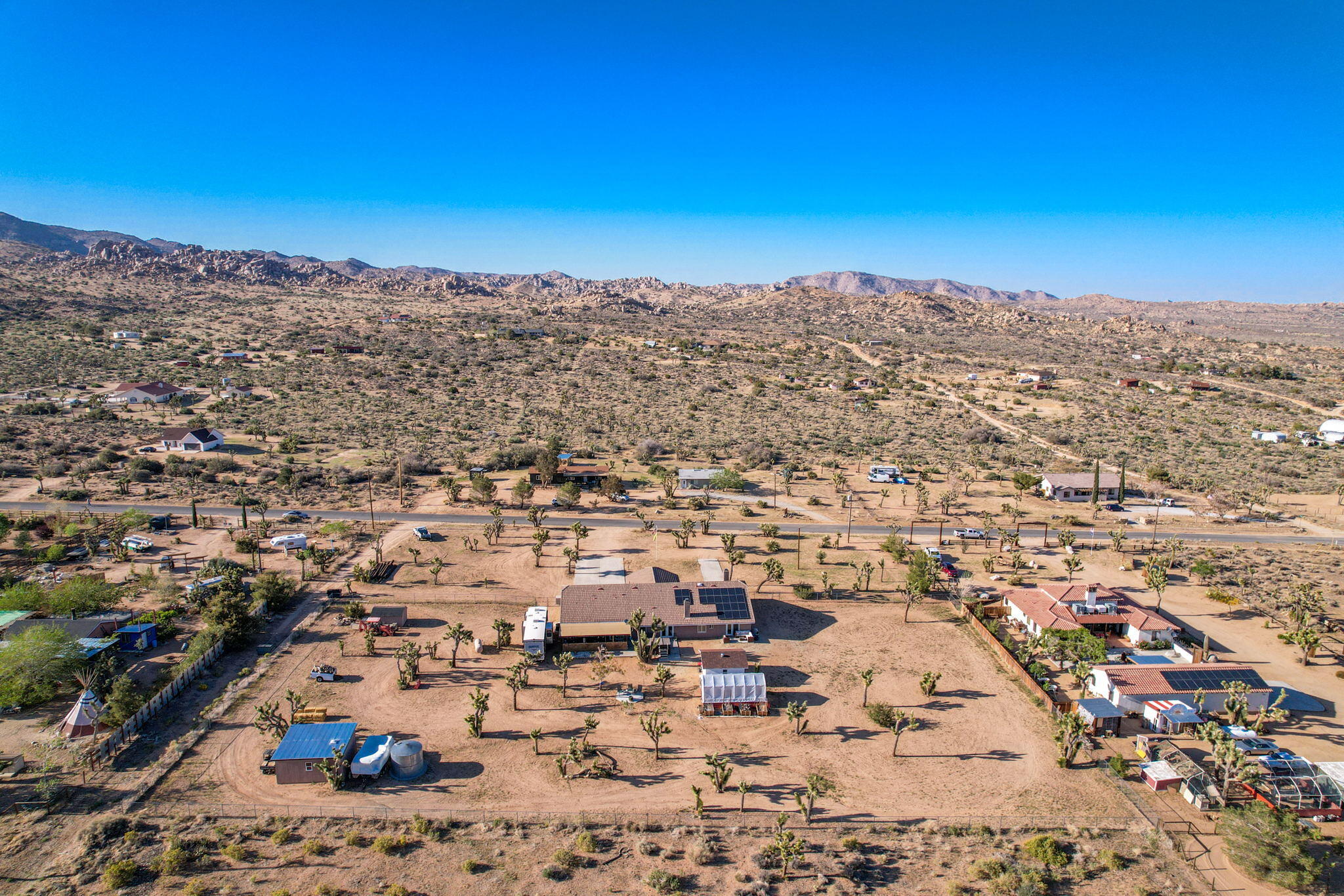 Wow!  A rare opportunity to be able to own an incredible home on 2.5 acre parcel in the world famous Pioneertown.  This custom designed home has been fully remodeled and features and open floor plan with high ceilings, paid off solar with a Tesla battery back up wall, new pressure tank for the well, ceiling fans and LED lighting throughout, new whole home evaporative cooler, GE Profile stainless steel appliances, new carpet in the guest rooms, tons of storage throughout the home, 2 automatic doggie doors with security locks, a large greenhouse and swim spa in the backyard along with 3 storage buildings one of which could easily be used as a guest room or playhouse.  Backyard if fully fenced.  This home is located just a few miles from the Famous Pappy and Harriets, a few houses down from the Rimrock Ranch and 28 miles from Big Bear the off road way.  This is a perfect place for anyone looking for a private getaway, primary home or income producing short term rental. Call today for your private showing.