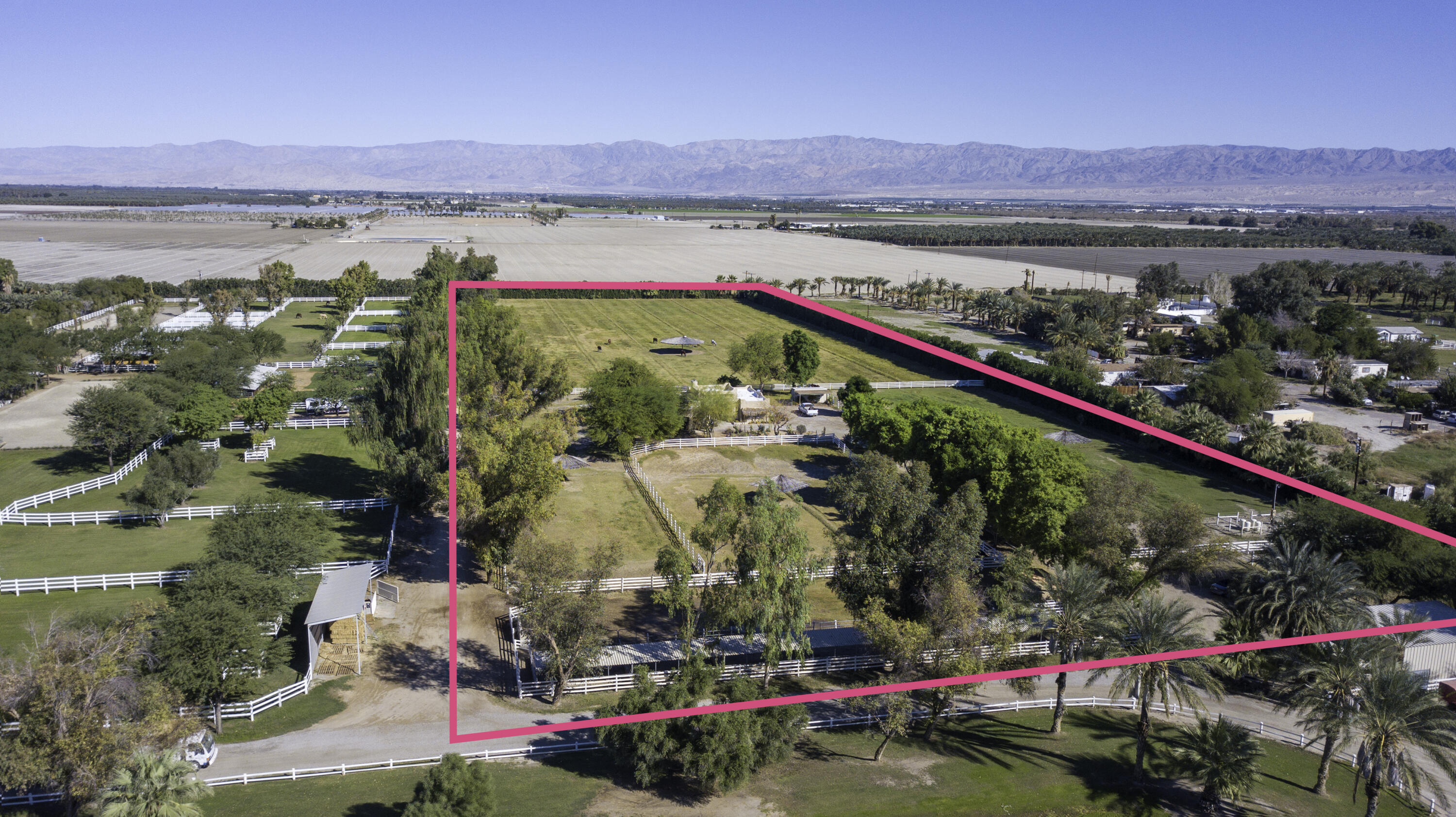 One of the best parcels in the gated, HOA community of Deer Creek in Thermal, CA.  Situated in the Eastern corner, this 10.3 acre farm has direct access to the field and track.  This parcel also shares a private driveway to Avenue 61 with the neighboring farm.  A 400 ft., tree lined driveway rises past the tack room and 7 stall barn area, to the elevated custom adobe style home in the middle of the farm.  Almost every room in the 2002 built home, looks over the pastures, all of which are fenced with 4-rail white Centaur fencing.  The home is approx. 1900 sf and has 2 bedrooms and 2.5 bathrooms in the main home plus a third bedroom/office under the carport.  There is an outdoor shower under the stars, and direct access to the main home's powder room from the third bedroom/office.  Saltillo tile floors, natural wood cabinets, a custom wood burning fireplace, art niches, and spectacular views over the grass pastures.  25 horses can live here comfortably!  A private well, and CVWD Ag water for pasture irrigation assure plentiful grass.  HOA ($900/month), includes reservoir, track and field maintenance, 2 playing tickets and management, water and manure removal.