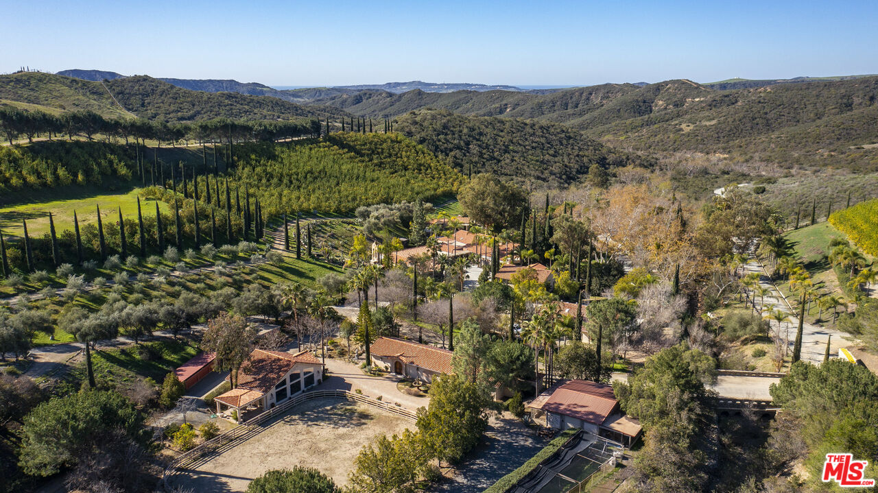 Located seven miles north-east of historic San Juan Capistrano, this 1225 acre estate rests quietly at the intersections of Orange, San Diego and Riverside Counties. Crossing the forever preserved, open cattle ranges of Rancho Mission Viejo on a private road, 23,000 certified organic lemon trees and 1000 olive trees imported from Pistoia, Italy provide the only obvious landmarks to find this totally off-grid, impossibly opulent and luxurious Tuscan Villa resting in a lush valley at the heart of the Ranch.  You will soon see the Lion-guarded entry portal which takes you across the stone-arched bridge past Lago Di Cigno (swan lake) to the main house.  The single story, main house is 5,048 sf 4 bed, 3 baths and a light-filled logia with panoramic lake views. The large master suit overlooks Lago di Cigno and connects to the opulent master bath with step-up tub and large walk-in shower. The chef's kitchen includes a Viking range and oven and a Sub-Zero Double refrigerator. A second, pool view master bedroom sits on the other side of the house. Guest rooms off the logia give everyone privacy and comfort.  Additional rooms include a den (man cave / trophy room), a laundry room, and an extra walk-in closet. There is central air conditioning and heat. Across the breezeway, through doors from Hearst Castle, the wine tasting room has temperature-controlled wine storage and a cigar-smoke ventilation system.  The swimming pool area is serviced by a full, indoor kitchen with a vintage Wolf stove and three, private bathroom stalls and showers.  The 2112 square foot office, museum and chapel next to the main residence offers a unique workspace and a chapel with a full-size replica of "La Pieta", Michaelangelo's sculpture displayed at St. Peter's Basilica, the Vatican. Seller commissioned the 10k lb statue from the same artisans who repaired the original after it was attacked by a madman with a hammer in 1972.  (This statue is not included in the sale but may be purchased separately).  Numerous other rare and valuable statues that ARE included in the sale:  A fifteen-foot-tall bronze Neptune from Florence Italy guards the swimming pool, three Dale Evers statues sit as a backdrop to the hot-tub, and in the garden walk and around the lake, you will encounter a variety of marble Renaissance statues, each worthy of hours of conversation.  The main driveway is occupied by "Il Porcelino", a bronze wild boar statue from Florence, Italy.  There is even a quick trip to the East via the Asian garden and aviary scene featuring three, full-size terra-cotta soldiers from Xi'an, China.  If you look closely, you will even find St. Junipero Serra tending to a coyote.  If you can't get enough art, you can create your own in the 2000+ square foot artist studio with vaulted ceilings and floor-to-ceiling windows for natural light.  You can then showcase your art in the 2175 square foot art gallery with museum quality, halogen track lighting. From the art gallery, you can head to the Equestrian Center featuring a four-stall barn with an office, bathroom and trophy room.  Train your horse in the riding arena or ride for miles on trails and roads across the Ranch.  You might even ride through the olive orchard to the 51 acre exotic animal preserve.  The sale includes the elegant Giraffe, the dozen grazing zebras, six African Antelope, a shy Kudu and a few Andean Llamas.  You'll have to look hard for the two, wise desert tortoises strolling slowly down by the barn.  Go fishing below to your private, two-acre lake with bass and catfish.  After that, true your aim at law enforcement quality rifle range.  Or you could ride to the high-point of the property for ocean views, Catalina views and views of the Newport Coast. Also includes: Two-Story Guest House, Gym, Aviary, Dog Kennels, Green house, Observatory, Wine Gazebo, Helicopter Pad, Pistol Range, Horse Corrals, 2200 square foot garage, 2200 square foot workshop,  2100 square foot employee triplex.