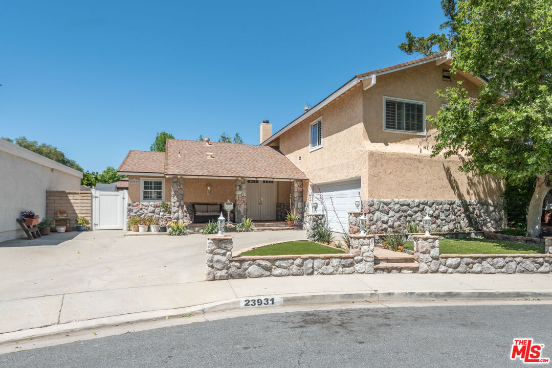 23931 Via Danza Valencia, California This highly sought after California location, location, location spacious five bedroom four bathroom pool home on a private cul-de-sac is in a very desirable community of Valencia. It is in a setting of total privacy with mature trees. Upon entering, you and guest will be greeted by the spacious open living area featuring an amazing view of the lovely entertainers backyard, great for swimming and lounging. The downstairs is designed with open dining, living space, cozy fireplace, custom shutters, and recessed lighting throughout, it also has two bedrooms and two bathrooms with attached garage. The chefs kitchen has custom cabinetry, built in appliances, and oversized island with chairs, this is a perfect space to chat while preparing meals. This privacy offers tranquility, yet near Magic Mountain, freeway access, restaurants, and shopping. Don't miss this rare opportunity to make this house your family home in the family culture community of Old Orchard II Village. This community offers walking distance to the wonderful paseos where you can walk, run, and ride bikes It offers award winning schools, parks, community pools, dining, shopping, and easy access to freeway.