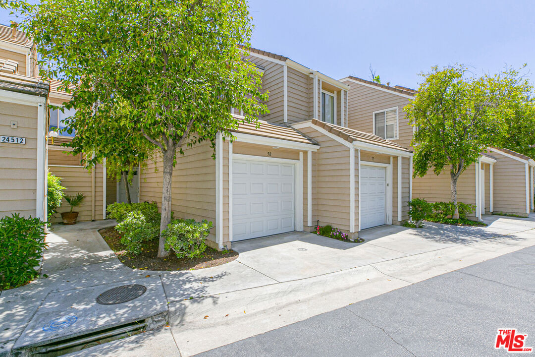 24512 Mcbean PKWY 58 Santa Clarita, California Welcome home to this gorgeous Franciscan Hill townhome in Valencia. This 2 bedroom and 2.5 bath unit has over 1,200 square feet of living space and has been very well maintained with various upgrades throughout. The first floor features a tile entryway, direct access from the garage, renovated eat-in kitchen with tile flooring, stainless steel appliances, breakfast bar with pass-through window to the formal dining area, step down living room with a built-in, wood flooring throughout, corner fireplace and sliding door to the balcony with storage closet and a view. Guest bathroom is located near the entryway. The second floor features 2 en-suite bedrooms, walk-in closets, 1 room with a fireplace, wood flooring throughout, laundry closet with stacked washer & dryer, and a skylight with lots of natural light. Guest parking and community pool & spa just steps away. Centrally located, minutes from CalArts, College Of the Canyons, Valencia Town Center, restaurants, and the 5 freeway!
