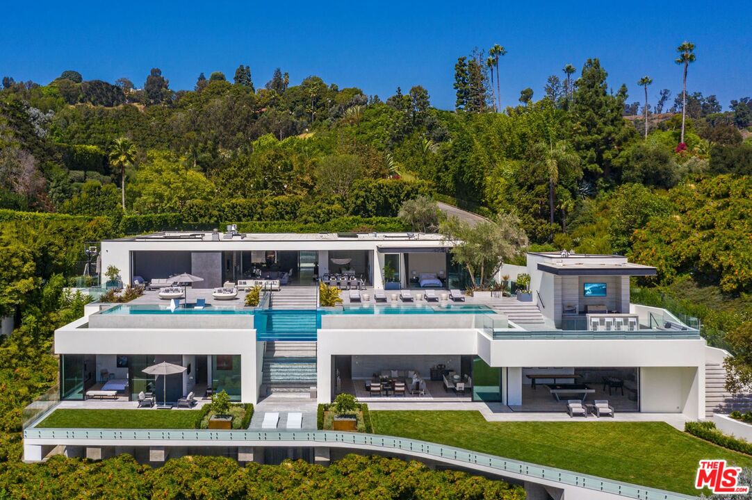 1251 Tower Grove Dr Beverly Hills, California Visionary owners joined forces with acclaimed architect Paul McClean and interior designer Lynda Murray to build this one-of-a-kind estate as featured in Le Chat, Modern Luxury & Vie magazines. Brand-new construction set in Beverly Hills on over an acre of land. Notably McClean's finest work to date. Minutes from the Beverly Hills Hotel, Rodeo Dr. & world-renowned entertainment. Every facet is perfectly crafted, culmination of the rarest, most unique materials & finishes worldwide with top-of-the-line appliances & amenities. Enjoy barrierless indoor/outdoor living & jetliner views from Century City to the Pacific Ocean. The estate includes a luxurious master suite, office, guest wing, home theater, gym, game room, BBQ, fire pit, lounge, spa & two pools connected by a never-before-seen transparent water bridge. Imbued with style & sophistication, rarely does an estate of this caliber come to market. Live the life you've always dreamed of in the most sought-after zip code in the world.