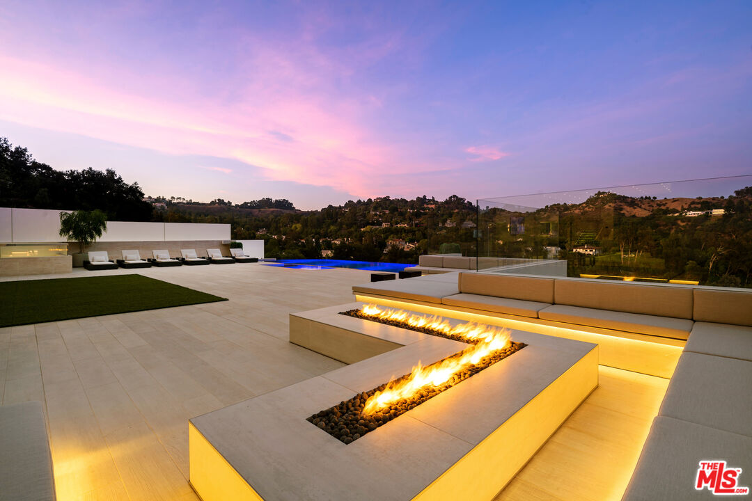 Classy double gated contemporary w/dramatic views, designed and built to the absolute highest level by one of Beverly Hills premier developers as his own residence. Located on one of Beverly Hills only private gated streets with just 14 homes & two tennis courts & a wide street with unlimited parking. Featuring a total of 8 Beds & 12 baths w/ a separate guest house w/ approx. 2,000 SF perfect for guests, recording studio, or a company office including 2 suites, indoor & outdoor living rooms, kitchenette & a theater.  Palatial master suite of approx. 2,000 sq ft with oversized his & her baths and closets, large office, kitchenette & a covered heated deck. 4 additional suites on second floor & a sixth suite with a side entrance on the lower floor. Perfectly scaled living, dining, family room & Chef's eat-in kitchen all open to the breathtaking views. Covered heated outdoor living room with a fireplace, full BBQ kitchen, cozy firepit seating for 25, outdoor dining, glass pebble infinity pool with a spa.  20 tv's & a massive sound system. 20 minutes to Van Nuys private airport and 10 minutes to the Beverly Hills hotel, minutes to gourmet market, fine shops, restaurants, salon and workout studios at the Glen Center for every convenience possible on this exclusive gated enclave.