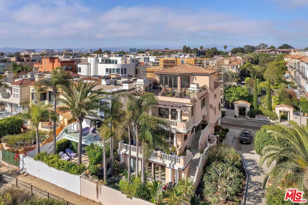 This sophisticated 5 bed/7 bath Italian villa overlooks the canal, channel, ocean, and beautiful sunsets of SoCal. It is perfectly situated on one of the largest and rare corner lots on the Silver Strand of the Grand Canal in Marina del Rey, complemented by various unique touches and resort-style finishes. Beautifully landscaped and designed lengthened private walkway to the grand entrance. Step into this beautiful custom-designed masterpiece. Grand step-up entrance, custom-designed fireplaces, vaulted ceilings, and windows all around for sunlit ambiance. This is a resort beach living at its finest. Gracious gourmet entertainers kitchen with top-of-the-line appliances and a walk-in pantry. The home has a 4-stop elevator and an impressive dining and living area. Sweeping ocean, white water, channel, and canal views from the gracious outside decks and interior sections of this stunning villa. The primary suite has impeccable space, a romantic fireplace, a study area, and additional unimaginable dreamy water views. A huge walk-in closet, dual vanity, and the primary bath includes a relaxing soaking tub with stunning direct water views and a Mr. Steam shower. All en-suite immaculate guest rooms. Sophistication and Opulence at every angle. The backyard is a tropical oasis by the beach with a heated Jacuzzi, waterfall, luscious gardens and trees, and two-private entrances. Bonus room on the ground level can be a library, office, or entertainers playground. Additional bonus room on the top level by the 5th bedroom for gym, game room, office, or art studio. Gorgeous extensive rooftop and flawless design capture the iconic southern coastal views, including Playa del Rey bluffs, Palos Verdes, white water, and picturesque city views. Private 3-car garage. 5,500 sqft. of interior space plus approx.1,500 sqft of ocean view outdoor deck space, making it feel like a 7,000 sqft. home. Steps to the canal, beach, and just minutes to marina, shops, and the best restaurants. This home is also for lease for $19,500 a month.  Seller will carry note up to 80% of purchase price--terms negotiable.  Only on approved credit/ECOA.
