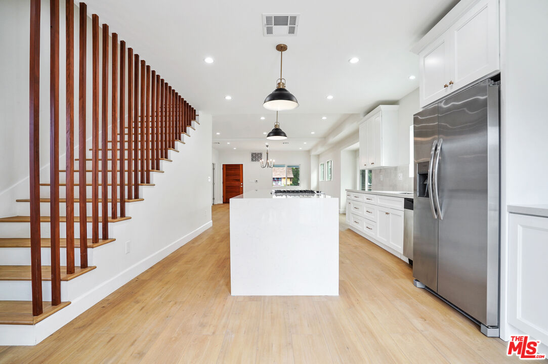 1036 1034 W 46Th St Los Angeles, California Charm, luxury and Character defines this beautiful Craftsman 4 beds 3 baths 2 story single family home (2,100sqft) with a detached 2 beds/2 baths (860sqft) guest house, ready to move in. If you love wood beams, attics, large back yard, large rooms, open floor plan and a large detached guest house this one is for you! This house welcomes you via a stunning front porch with rock-stone details. The large living room with a beautiful light fixture opens to a gorgeous kitchen with beautiful pendant lights, great setting-to invite the family for a Thanksgiving dinner. The bathrooms finishes are also to die for. Large 2nd story through it's beautiful decorative wood stairs is a Family's & kids dream. Enjoy the spacious backyard perfect for large family gatherings, kids, pets, entertainment during your BBQ's and days of relaxation. Ample-sized driveway to accommodate more than 3 or 4 cars. Minutes from LA Coliseum, downtown Los Angeles, Staples Center and USC.