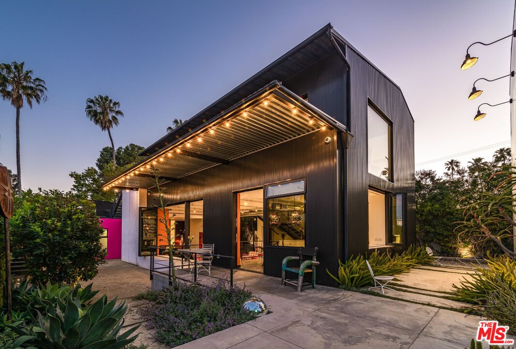 813 Palms Blvd Venice, California "The Art House", one of the most iconic homes in Venice. This widely published, internationally recognized property sits privately above the street behind a wall & gates, A green architectural masterpiece on a huge corner lot close to Abbot Kinney & the beach in one of Venice's most sought after neighborhoods (Milwood). An urban oasis w/ striking exteriors w/ an industrial warehouse feel, w/ sun-drenched interiors, an open floor plan & vibrant layers of color that evoke the purest sense of joy. Walls of glass open to several distinct outdoor experiences on all 4 sides w/ large-scale entertaining & plenty of room for a pool, including sunken courtyard, fireplace, 2 roof decks w/ views & ocean breezes, & featuring the worlds first residential commission by renown anonymous French street artist, Invader. Striking main suite on the 2nd level, while the 1st level features a high-functioning kitchen opening to the living spaces, plus 2 large guest bedrooms. Across the courtyard is a 2-car garage & guest studio w/ great scale, perfect home office or high income rental opp. This unique architectural compound is a utopian sanctuary of art & life.