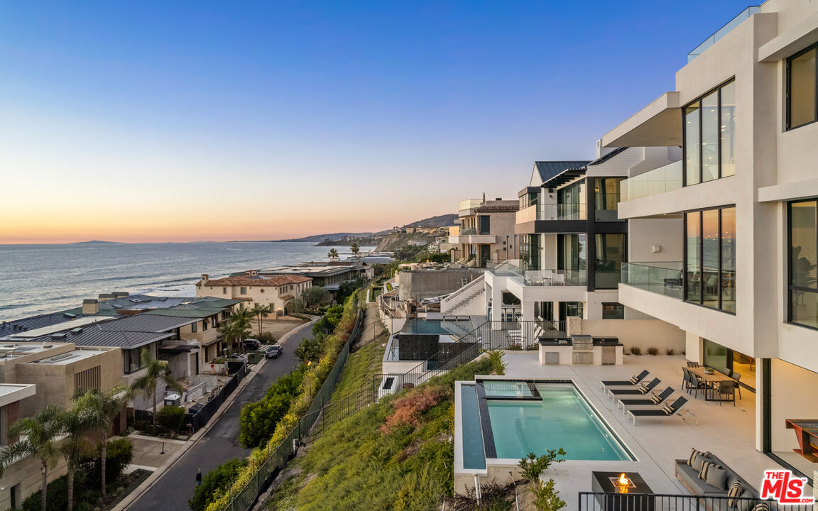 15 Beach View Ave Dana Point, California Crowning the very upper echelon of Orange County s unparalleled ocean-view estate occupies a league of its own at The Strand at Headlands in Dana Point. The modern coastal tri-level showplace reveals breathtaking white water ocean views that encompass shoreline vistas, Catalina Island, dazzling sunsets and Headlands Cove Vistas. Views are enjoyed from nearly every location within the estate with floor to ceiling windows on every level, slide-away-doors, and an open floor plan that is an entertainer s dream. The home spans approximately 7,800 sf, and boasts of 8 ensuite rooms, gym, office, 12- seat theatre, 8 full bathrooms, 2 half baths, elevator, wired as a smart home, top-tier appliances, marble book-matched kitchen, waterfall island, walk-in pantry, floating staircases, walk-in closets, over-sized laundry room, marble book-matched fireplaces, wine wall, beautiful marble book-matched wet bar with ice maker, fridge and floating shelves, built-in BBQ, built-in patio heaters within loggia, custom marble exterior fireplace and a 4 car garage. Uniquely positioned to entertain stylishly from its 700 SF roof top with 180 degree unobstructed ocean views.