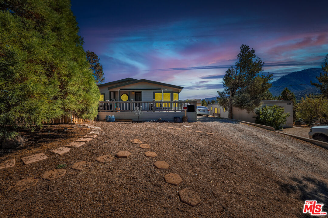 2720 Kodiak Way Pine Mtn Club, California This INCREDIBLE turn key home in BEAUTIFUL Pine Mountain Club California is waiting for you. BIGGEST ON THE BLOCK! This isn't just any home, this property features UPGRADES Galore. The Pride of ownership is obvious. Almost 2000 sq.ft. Stone Fireplace w/propane hookup. AC ready. 200 amp electric panel.. 10 x 12 storage shed. RV access. Stainless Steel appliances. Washer/dryer, Tank-less water heater & a water softener system. Laminate Flooring throughout. Master suite w/large walk in closet. Large shower stall & large garden tub. Fully landscaped w/sprinkler system. Wrap around Trek wood deck. Large patio w/Weber Barbecue w/propane hookup. Manufactured 433 home. Beautiful views and Fresh Mountain Air in an Alpine Valley at an amazing price!