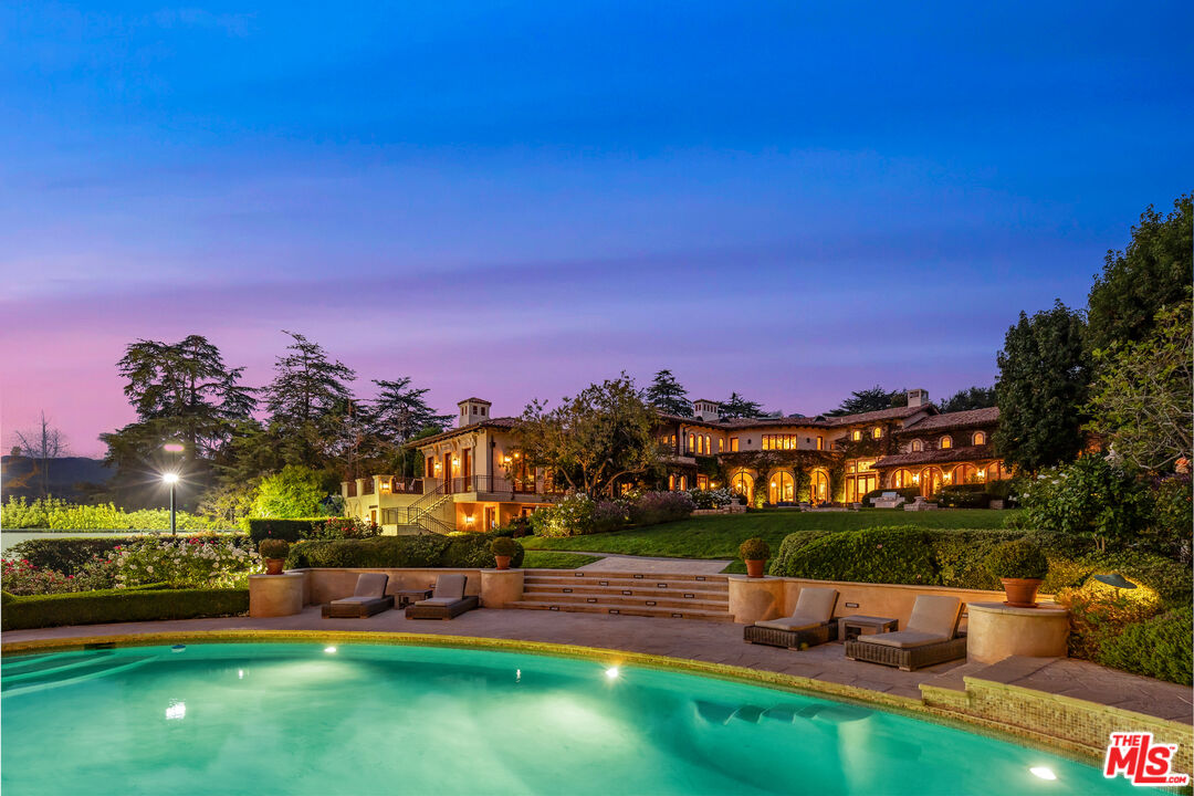 1550 Amalfi Dr Pacific Palisades, California Luxury living redefined at this timeless masterpiece. Designed by renowned architect, Richard Landry, this private Florentine villa inspired home offers iconic Westside living in one of L.A.'s most picturesque coastal regions. Step inside to find endless custom features including exposed beam ceilings, ornate tile flooring, and custom windows framing stunning mountain and ocean views. Unwind in several parlors opening to the sprawling grounds, ideal for indoor/outdoor living. The chef's kitchen offers world-class appliances, marble countertops, and custom cabinetry perfect for next-level dining.Relax in the spacious primary suite with resort inspired bath, as well as several ocean-view balconies.Outside you'll find the 1.7-acre grounds with pool, cabana, tennis court, guest house and putting green. Screen films in the theater or host celebrations in the 2-story family room and formal dining room. Situated minutes from pristine beaches, this captivating coastal estate offers unparalleled luxury and tranquility.