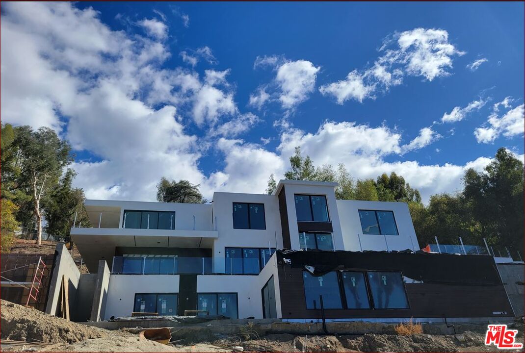 21800 Lopez St Woodland Hills, California An outstanding opportunity for builders and investors to purchase and complete the construction of this brand new estate and a separate ADU which are about 75% completed. Ultra-modern contemporary architectural estate perched on a hill at the end of a cul de sac on two parcels with the lot size of approx 26,000 sqft featuring 5 BR, 6 BA, Approx 6600 sqft main house designed for a wide-open floor plan with ample natural light, floor to ceiling high quality Fleetwood sliding glass doors, massive terraces on each floor to maximize the indoor/outdoor flow and the enjoyment of beautiful city and mountain views. Architectural design features include separate ADU which is approx 1100 sqft, top floor master suite which is over 800 sqft with steam shower with private terrace enjoying the views, 3 car garage, 5 En-Suite bedrooms, basement level featuring a game room, gym (5th BR) and spa, movie theater, wine cellar and storage. Fabulous opportunity for the buyer or investor to create their dream estate by contributing their imagination to the final touches. Located within minutes to the Commons at Calabasas, to the renowned Westfield Village and Mall, future Rams development site, Woodland Hills Country Club, Serrania Park and Freeway 101. Short drive to Malibu.