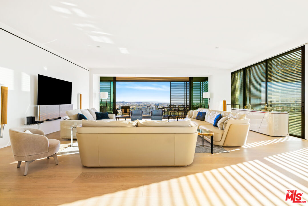 The ultimate in luxury, 3432 sq. Ft. 3 bedroom 3 baths and powder room. Breath-taking panoramic views w/ floor-to-ceiling windows and sliding walls of glass open to the loggia creating a sprawling indoor/outdoor living space with sweeping views of Downtown LA to the ocean on the south and the iconic Hollywood Hills to the north. Designed by AD100 architect, John Pawson this elegantly-designed teak and Basaltina stone Molteni kitchen offers a dramatic island and top-of-the-line Miele appliances. 11.5" wide planked white oak floors flow throughout the interior. The master suite with electronic balcony doors compliment the spacious highly upgraded master closet and master bath. Two additional bedrooms with Hollywood Hills views luxurious en-suite baths all finished in Basaltina stone with floating cast concrete counters and rain showers. White oak-paneled powder room, and utility room with side-by-side washing machine and vented dryer compliment the residence.All the five star amenities you would expect, fitness center, spa, owner's pool plus rooftop hotel pool and bar, world class restaurant, room service, private owners parking garage, entrance and elevators along with 24-hour concierge and doorman.