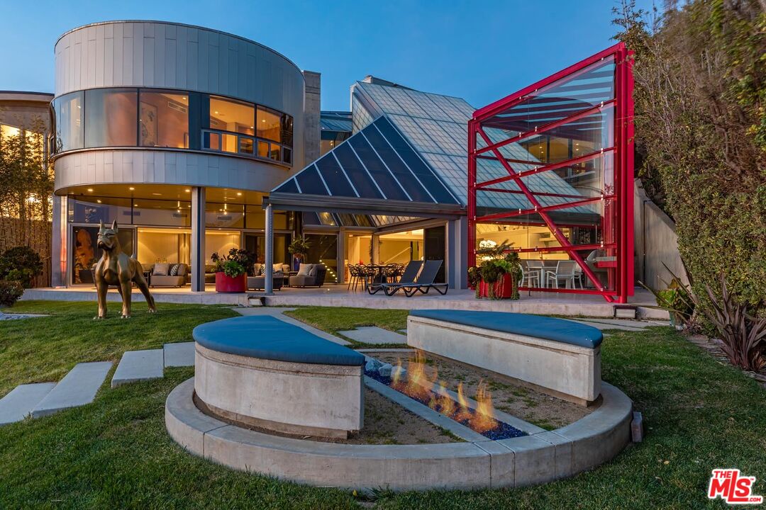 A multi-generational compound with a global architectural pedigree is not often offered on the open market. This iconic Edward R. Niles-designed modern masterpiece (GA Houses Project 2005 "Chen Residences) is one of the most spectacular homes of glass and steel along the Southern California coastline. Striking interiors rival that of world-class contemporary art museums. Think Guggenheim in New York and Bilbao, Spain, and The Broad in Los Angeles. Niles' signature architecture is appreciated for its dramatic futuristic design while showcasing the splendor of its natural surroundings. Connect with nature living on approximately 75' of a pristine fine sand beach with a captivating tide pool (Harrison Reef). Drawing inspiration from the shoji concept of translucency (a traditional style of Japanese architecture), the expansive 4bd/5.5ba main house with detached 1bd/1ba guest house lives large at 8,206 square feet. Niles' design of glass, steel, and concrete created a modern, yet timeless art piece most appreciated by the collector of unique properties. The home's design incorporates the lucky number "8" which is thoughtful yet strategic. Eight separate structures were created as one with art and furnishings showcasing the number "8."  Feng Shui-inspired design ensures a significant balance between the home and its natural surroundings of ocean and sky.  An exposed architectural concrete wall adds to the distinctive design. Privacy and security are assured as the home is well-gated with a 2-car garage and ample guest parking. A fully remote-monitored security system is convenient and appreciated. Engineered and constructed to sustain the forces of nature from a tsunami to an Earthquake. For added self-sufficiency, there is an on-site generator.  The .83-acre property rests on one of Malibu's quietest and most pristine beaches.  The one-of-a-kind amenities include a state-of-the-art music room, a soundproof home theater (for 19) with hardwire built-in streaming connection. There is a built-in audio system throughout.  Interior features to be appreciated include an exposed architectural concrete wall, and Gascoigne Blue natural limestone flooring in bathrooms, and on the patio.  Bulthaup design cabinets in the kitchen and throughout the home offer simplicity and function while incorporating a purist design. Dornbracht luxury stainless faucets in the kitchen and baths are "timeless and iconic." In addition, there are nine Sub-Zero refrigerators throughout. A hydraulic (nearly silent) elevator accesses all four en-suite ocean-view bedrooms and living spaces. Abundant open space around the property can host over 100 guests. An outdoor fire conversation pit, and a stainless-steel Japanese soaking tub complete the picture.  Whether it's entertaining friends and family or escaping daily life one can fly private directly into the Camarillo airport and be on the sand in 20-25 minutes. A truly unique architectural masterpiece for those who appreciate the privilege of ownership.