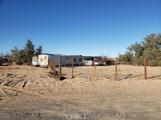 Price drop again on this one of a kind property, come and take a look. Almost 5 acres with power, water and septic. 2 parcels in one sale, and both parcels already have addresses - this lot sells with the one directly next to it, 39374 Mohave Ave, Newberry Springs, CA 92365. Property is right off the freeway and directly across from 2 new gas stations/convenience stores. Owner's family has lived here for many years. There is a single wide mobile home on the property that has been, and is currently, being lived in by owners family, however, is not on permanent foundation, so will not be part of the sale but will be left on the property. Power, water and septic all currently working (but seller unaware of current condition of septic, buyer will need to do due diligence). Mobile home is in fair condition, owner will not make any repairs or give any warranties on it, it will be left as-is. The property has 2 wells (one working, one that needs updating), a man-made pond (empty right now), and several outbuildings throughout the property. This is a great opportunity for primary living OR, can maybe be re-zoned commercial/rural commercial for a business opportunity that's right off the freeway.