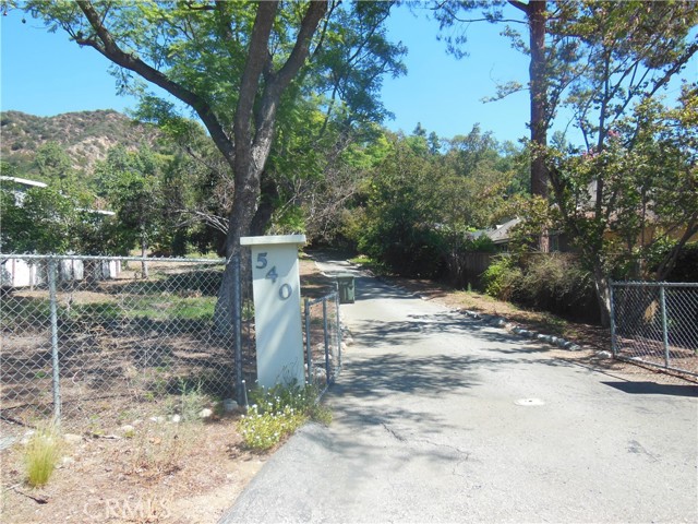 Opportunity to develop your own gated mini-estate in the foothills of Monrovia. Currently there is a house, guest house, carport and avocado & fruit trees on the property. The buyer also has the option of completing the application for a SB9A Tentative Parcel Map, which when recorded would divide the property into 2 parcels and permit the building of 2 SFR's, each with its own ADU.   This is a Trust Sale, no court confirmation required.  Structures on the property convey "as-is" without any warranties expressed or implied. Offers subject to inspection.