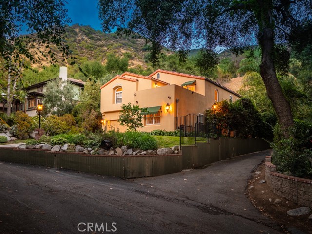 This lovely Mediterranean home is located in the Private Pasadena Glen community, one of the most beautiful spots in the foothills! The two story entry with its dramatic staircase greets you as you enter, opening to a large living & dining area with its many windows, central fireplace, and built-in bar. Adjacent to the living room, there is a family room with large built in, currently used as a home office.  The custom kitchen offers stainless steel appliances,Center Island, and quartz counter tops. Off the central hall upstairs are two nice size bedrooms, a full bathroom, and a large master suite complimented with vaulted ceilings, en-suite bathroom, walk-in-closet, and sun room.  In addition, upstairs there is a large open air deck overlooking the canyon with amazing tree top views!  The outdoor space is really something special! An entertainer s dream, that includes outdoor kitchen with granite counter tops, stainless steel appliances, dining area and beautiful fireplace. But there is more .this incredible outdoor oasis has additional patios and cozy seating areas perfect for entertaining family and friends or quiet evenings at home.  To make this property complete, there is a 176 sq ft Artist Studio / Workshop / Casita.  All this situated just minutes away from hiking trails, golf, shopping, restaurants, markets, and transportation. A must see to believe!