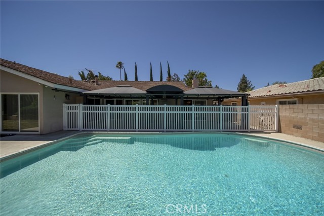 Poised in the beautiful San Fernando Valley, is a Chatsworth pool home that is ready for new memories! This charming property offers a beautifully landscaped property with an attached 2-car garage. Property has ADU potential! Newly upgraded home with 5 bedrooms, 3 bathrooms and 2,834-SqFt. Interior features include upgraded flooring, baseboard moldings, airy rooms, recessed lighting, and plenty of storage space throughout the home. There is a spacious living room with a fireplace and a formal dining area with a sliding door that has a pool view. The kitchen has built-in appliances, white tiled countertops, as well as beautiful wood cabinets. At the end of the kitchen, you have built-in cabinets and a built-in desk.  The home has spacious bedrooms that have tile flooring and ample closet space. One bedroom has a beamed ceiling and a fireplace and a sliding door that has easy patio access. There is a primary bedroom with a private bathroom equipped with a built-in dressing table and a soaking tub that is perfect for relaxing after a long day. Separate laundry room. The home sits on a 10,890-SqFt lot that has a large front and back yard. The backyard presents a calming setting with a fenced swimming pool, a covered patio and a small grassy area that is great for pets. Located near schools, the Northridge Fashion Center, supermarkets, popular dining options and the Newly opened Porto s Bakery and Café.