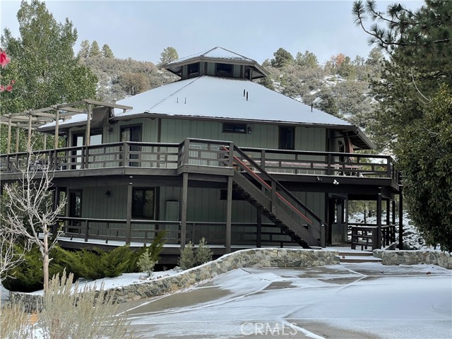 Just in time for the holidays, Tucked away in the desirable Pine Mountain Club community, over 3,000 Sq, Ft, Five bedrooms,( with potential for Six Bedrooms),  four bath, two-story home is the retreat for large gatherings or just need room to take your family and friends Price Includes APN #328-076-04-00-4 with an additional 10,762 sq ft of buildable land, totaling over 21,500 Sq Ft.- if you choose to build another home. massive open 24' T&G ceilings with a center roof with clerestory windows above a raised center dining room, chef s gourmet kitchen with five burner stove top, stacked microwave and oven, built-in commercial WOK with overhead commercial dual exhaust fan, and stainless appliances. The rest of the top floor has a pantry/laundry room, master bedroom en-suite, second bathroom, guest room & an open concept, double-great room with wood burning fireplace.  Head down a spiral staircase to find another living room, 2nd wood-burning fireplace, a game room, 2 bedrooms and 2 baths, kitchen/laundry room.  Both floors have their entrances & 360-degree decks on both floors with stunning mountain views and the Apache Saddle sunsets. The community of Pine Mountain Club has four mild seasons and features include security, a clubhouse, a pool, golf, tennis equestrian and so much more.