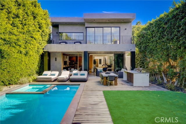 Modern Home RETREAT by Architectural Digest acclaimed designer/builder Adam Rimon. Nearly 6000 sq. ft of Indoor/Outdoor Living area on a 7413 sq. ft Lot. You will never believe you are in the midst of Hollywood/Melrose/Beverly Grove. The oversized lot with grassy yard, Pool Waterfall, Baja Deck Spa brings a ZEN presence to your surroundings. The Control 4 smart home has Open floor plan, Fleetwood glass doors, high ceilings, great room with large Italian porcelain tile flooring, entertainer chef's kitchen with quartz waterfall island, finest appliances, custom European style cabinetry, climate-controlled Wine Closet, downstairs bedroom converted into movie theater room. Master suite with Fleetwood doors that open to the private balcony, fireplace, Wet Bar with Refrigerator and walk-in closet flooded with natural light. Master Bath with a steam shower built for two, soaking tub, and see thru fireplace. Rooftop Deck with Firepit, Wet Bar/Refrigerator, and 360 views of Downtown, Hollywood Sign, Griffith Observatory, all points west!!