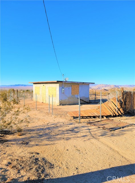 Come and take a look at this excellent opportunity to own your very own "Recreational Cabin" near the Johnson Valley OHV trails.  This parcel is 4.11 acres of desert land with a breathtaking view.  This structure has an electrical panel and a water storage tank / tower.  The interior of the structure has been mostly gutted and is ready to make improvements and go through a permitting process if desired.  Additions and upgrades to convert to a permanent living structure can be investigated through the County of San Bernardino.  This property is split by Highway 247 with the larger portion being located towards the South end of the property and the structure and smaller portion of the lot located on the North side of Hwy 247.