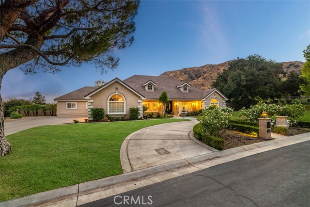 CUSTOM BUILT SINGLE STORY ESTATE SITUATED ON A QUIET CUL-DE-SAC OF THE MOUNTAIN SPRINGS GATED COMMUNITY. Enjoy breathtaking curb appeal with a stunning mountainside backdrop, a circular front driveway, a long second driveway leading to a three-car side entry garage, and potential RV parking. Double doors lead into an impressive open floor plan offering 12' ceilings, a chandelier, tile plank flooring, a formal living room, and adjacent formal dining room with skylights. The open family room features a marble fireplace surrounded by a built-in media center, wood tiled plank flooring, recessed lighting, a sliding door to the backyard, and views of the pool and mountains. The kitchen features classic white cabinetry, quartz countertops, white appliances including a built-in Sub-Zero refrigerator, Viking range & vent hood, an island with seating, and pendant lighting, a walk-in pantry, a buffet counter with glass uppers, and a spacious breakfast nook w/panoramic views. The bonus/game room offers retro flooring, and has a 50's diner feel with built-in booth seating, Coca-Cola wallpaper, and backyard access. This room could convert to a junior primary bedroom. There is a theater room with speakers, a projector, and screen. A home office with double door entry is located off the front doors and has back hall access and could be converted to another bedroom. The primary bedroom offers double-doors, a cozy retreat, and a sliding door with backyard access. The remodeled primary bathroom offers dual sinks with quartz countertops, completely remodeled walk-in shower, a soaking tub with a view, double entry walk in closet, and a private water closet with a barn door. There are also three additional bedrooms, two hall bathrooms, and an oversized laundry room with direct access to the attached three car garage. The backyard features a pool and spa w/water features, a built-in BBQ with a Viking grill, Viking ice maker, and a Fire Magic fridge. There is a covered patio made of alumawood with a ceiling fan, grass areas, landscape lighting, spacious side yards, a storage shed, and views of the mountains & city. *Grass is photoshopped due to watering restrictions.