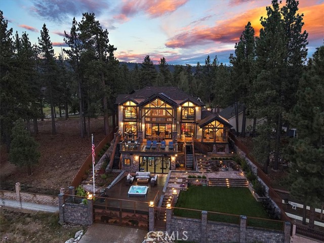 Perhaps the most spectacular lakefront estate in all of Southern California, once you've seen in person this home's warm, inviting rustic mountain architecture combined with beautiful lake views and almost an acre of deep-water, wind-protected lakefront land, you will know that this is the home you've been searching for. The floor to ceiling windows looking out to the lake will enchant you, and the vast amenities this home offers make it an unmatched luxury experience. This home was made for both relaxing visits as well as entertaining all of your friends and family. There's room for everyone in the seven bedrooms, one of which boasts 4 custom-made queen-sized bunk beds for all the kids (or grown-up kids) in your family! The spacious great room feels warm and inviting, and has something for everyone, from books and games, to a pool table and a wet bar. Outside, you will find multi-level decks and patios surrounded by gorgeous landscaping, a spa overlooking the lake, and even a fully equipped gym with a stacking glass wall that opens completely to the outside. Don't miss your very own park featuring a turf soccer field, basketball sport court, and custom built treehouse with electricity, complete with water well. There's even newly installed solar panels that charge 4 separate Tesla batteries providing stored power to the property, smart home capabilities with a 20-zone Sonos sound system and 7 heating and air-conditioned zones, gated entry with custom metal artwork, canopied deep-water, wind protected boat dock with planned expansion, and a premium security system. There are so many bonuses to this home that it is impossible to list them all here; this is a MUST-SEE. Winter, summer, spring, or fall, this is the perfect home for you to create your mountain paradise, and to make memories that will last a lifetime. Ask your agent for a more complete list of features!