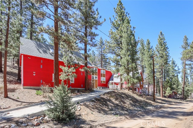 Wow! Spacious and custom built estate tucked away in the Sugarloaf forest off of Inyo. Approx. 4 acres of raw national forest surrounds this pristine property. Backs to national forest. Unique floor plan offers 2 kitchens, truely immaculate and turn key! Off the beaten track for sure and room to expand as you wish or add a horse or two. Beautiful sweeping views from upstairs master bedroom and family/game area. Some extras in the kitchen include self closing cabinets and sliding drawers, convection stove and microwave, instant hot water. Also of note-2 water heaters, compressed air access, central vac, large garage with 2 work areas (heated) above garage. Roof is 20 years old and in great shape, plumbing and electrical all in top shape, Intercom system, owned security system, large closets and loft style bedroom to enjoy story time. Come see this charmer, "Big Red"! Boat dock included with sale (located in Pine Knot Marina). 2 parcels are being sold together. Make an appt today!