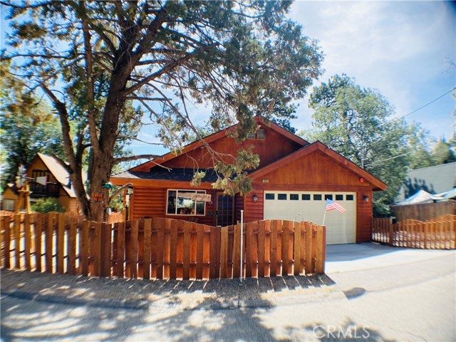 Welcome home to the beautiful Big Bear community of Sugarloaf!  As soon as you drive up to this property, you will instantly notice the charm and beauty that radiates off the house with the custom made fencing, joyful touches, and classy log cabin look.  This spectacular place has everything you need to make your perfect new home, or the most amazing relaxing getaway retreat! This well loved and maintained home sits on an oversized lot that feels more like your own private park, with more than enough room for those summer BBQ's and parties with your friends and family under the pergola.  Rock the rockers on the front porch enjoying your coffee while listening to the birds as you wave to your amazing neighbors as they walk by.    The highly desired open concept kitchen and living area will hold many new created memories with your family and friends.  The four bedrooms and two bathrooms make a wonderful layout for the modernized home that comes turnkey, and furnished, with everything that you will need, right down to the coffee maker!  This home is a newer 2016 build that was built with not only love in the walls, but also a whole house sprinkler system to protect the loved ones inside.  The spacious 2 car garage is a rare find on the mountain, and will easily store your cars, boats, bikes and snowboards!  Just a quick drive to the lake, biking/hiking trails, or snowboarding, this home is in convenient proximity to it all! Call us today for a chance to own one of the most spectacular homes around, as this beauty won't last long!