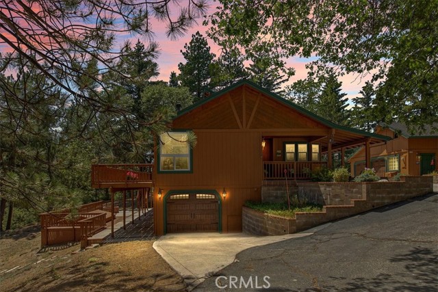 Own your own piece of forest in the private community of Rimwood Ranch, a highly coveted area of the San Bernardino Mountains! Situated on 5 beautiful tree-scaped acres and zoned for horses. This 4-bedroom 4-bathroom 3 car garage home offers so much and more! Walk in to find a warm and bright, cozy sunroom that leads you right into the level first floor featuring an open living room with a gorgeous tongue and groove wood ceiling, and a brick wood burning fireplace. Open to the living room you'll find an updated kitchen with Corian countertops, breakfast nook and newer appliances. Head down the hallway to find the main level master bedroom featuring a large walk in closet and gorgeous updated bathroom with a clawfoot tub, large shower and self-closing cabinets! 2 large bedrooms and bathroom are also located on the main floor. Head downstairs to find a large game room equipped with a pool table that comes with the house and access to the lower deck featuring a jacuzzi tub and brick firepit. Also, on this floor is a large laundry/craft room, full bathroom and bedroom. Other features include newer dual paned windows, whole house generator and air purifier, compressor, alarm system, newer A/C, skid steer, horse barn/stables, corral and more storage than you'll ever need! This home is functional, well cared for and perfect for large family gatherings. Don't miss this opportunity to own your own piece of heaven on earth!