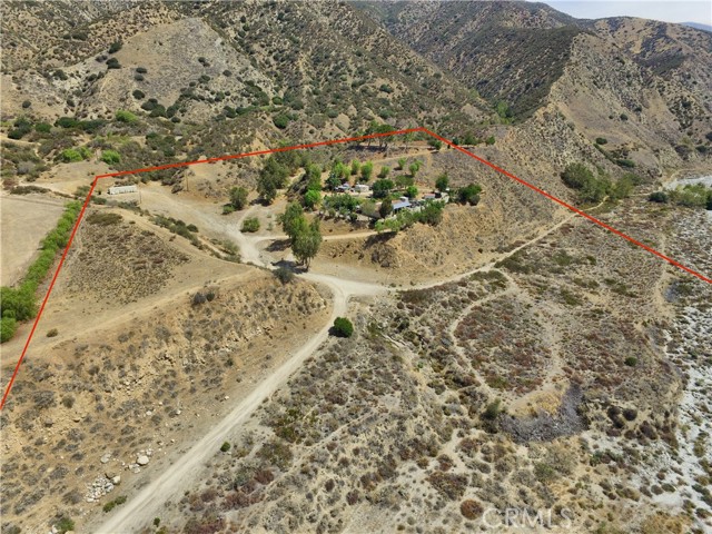 Rare find/opportunity awaits! Situated in the foothills overlooking Oak Glen/Yucaipa to the East, the San Bernardino mountains to the North, and the Inland Empire to the West, sits this beautiful single story home that features 16 acres of land. The home itself features: Almost 2,200 sf of living space; 3 bedrooms & 2 bathrooms; Family room with wood burning stove that is open to the dining area and spacious kitchen; Living room with large windows facing out to the spectacular views; Indoor laundry room; 2 guest bedrooms; 1 Guest bathroom; & Primary bedroom/bathroom. Bonus features include: Above ground spa, multiple storage containers, Central HVAC, 2 water wells, & PAID FOR solar system. The property is situated on the hillside and runs along/partly into the infamous Mill Creek. The property consists of 16 acres that are all included in 1 parcel and there are 4 difference levels/pads. The highest pad sits above the current home and would be a great place to build another residence (maybe turn the current one into a guest home?) because the views are over 180 degrees of beautiful scenery. With the local area rapidly growing and gaining traction with vineyards/wineries, let your imagination run wild with what could be done here. Looking for horse property? Look no further, plenty of room and the 2 wells would make this a great place to raise your horses/animals. It's hard to find a property this expansive, secluded, and boasting these kinds of views...so don't wait!