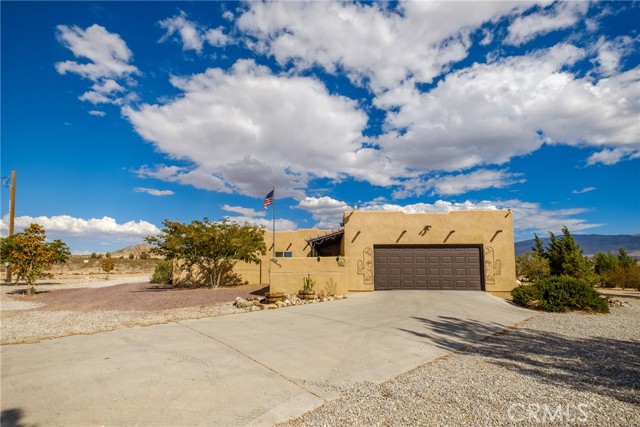 A Desert GEM! This BEAUTIFUL desert style home has everything and more! 3 bedrooms with 2 bathroom, located in a quaint area of Lucerne Valley with PANORAMIC VIEWS of the mountain, valley, and desert ranges! Just shy of 1,600 Sq Ft, the enclosed entry way greets you through the custom wood front door, to the open concept living space area, which is an ENTERTAINERS DREAM! This custom kitchen has been FULLY remodeled with a customized butcher block island, quartz countertops, brand new shaker style cabinets, built in appliances, as well as a formal built in dinette area! This gorgeous kitchen has exceptional natural lighting from its abundance of dual pane windows, and is open to the large living room area. The living room has oversized windows, exterior access to a private courtyard patio, accent wall, and has plenty of room for large furniture! All 3 bedrooms are exceptional size, with large closets! The master bedroom has access to an enclosed patio, walk in shower, AND walk in closet! Boasting on 5 acres, the property is fully fenced and cross fenced! On the bottom section of the 5 acres you will find a workshop like structure built with 40 ft containers! Electrical has been pulled to this area of the property, which makes an ideal area for more storage, a second residence, or even RV hook ups! If this was not enough his property has a private well in an enclosed well house, with a BRAND NEW submersible pump and pressure tank! The roof is also BRAND NEW and comes with a roof cert! Along with that, the home has a top notch security system, dialed in with alarms on every window and door, security cameras, AND flood lights! The pride of ownership is obvious from the moment you step through those gates! Seller is motivated, and has priced to sell!