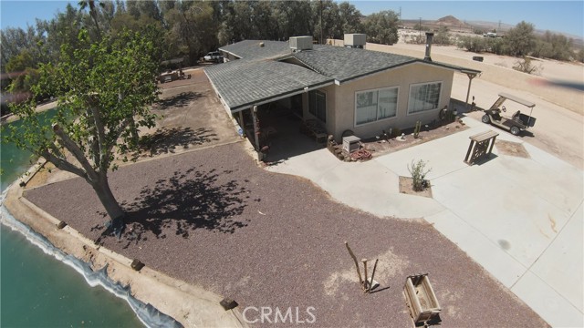 2 PARCELS MAKE THIS BEAUTY 5 ACRES!!! WAIT UNTIL YOU SEE WHAT THIS PROPERTY HAS TO OFFER!HORSE FACILITY , TONS OF OPEN SPACE TO RIDE , PRIVATE LAKE STOCKED WITH CATFISH, BLUEGIL AND BASS, COMPLETELY FENCED . A TRUE OASIS IN THE DESERT . THE MAIN HOME OFFERS OVER 1400 SQ. FT OF LIVING SPACE , WHICH FEATURES A BEAUTIFUL KITCHEN , WITH GRANITE COUNTER TOPS, CUSTOM CABINETS AND AN EATING AREA , BATHROOMS HAVE TILE , UPDATED VANITIES , COPPER SINK , HANDWARE, VERY NICELY DONE, A LARGE LIVING ROOM WITH A WOOD STOVE, VIEW OF THE LAKE, AND A AMPLE SIZE DINING AREA , TWO BEDROOMS AND LAUNDRY ROOM , IN THE BREEZEWAY YOU WILL FIND A SWIM SPA FOR EXERCISE  OR JUST RELAX WITH YOUR FAVORITE BEVERAGE, OVERSIZE TWO CAR GARAGE WITH A WOOD STOVE AND BATHROOM , WOULD MAKE A FANATSTIC MAN CAVE... LONG BACK AND FRONT COVERED PATIO'S , WHILE YOU ARE ON THE FRONT PATIO YOU WILL ENJOY A VIEW OF THE CALICO MOUNTAINS , BACK PATIO PROVIDES THE TRANQUILTY OF THE LAKE.  FISHING IN YOUR OWN PRIVATE LAKE , NO FISHING LICENSE REQUIRED , WHAT A RARE FIND , GET OUT YOUR FAVORITE CHAIR AND SIT ON THE BANK OF YOUR OWN LAKE AND FISH THE DAY AWAY..  NOW LET'S TALK ABOUT THE HORSE AREA , 4 STALL ENCLOSED BARN, 12X24 FT STALLS, 6 24X24 PENS WITH SHELTERS,A COVERED SHED ROW WITH 4 12X12 STALLS, HAY BARN THAT WILL HOLD A SEMI LOAD OF HAY , A FEED TRAILER , A TACK SHED , 130X16O  (APPROX)TURN OUT, SEPARATE 160X320 (APPROX) RIDING ARENA , TWO WASH RACKS FOR HORSES AND MINI'S , HOT WALKER, MULTIPLE PLACES TO RIDE RIGHT OUT YOUR ELECTRIC FRONT GATE. ALL THAT IS LEFT TO DO IS BRING YOUR HORSES! IF THAT ISN'T ENOUGH, THERE IS A ONE BEDROOM , ONE BATHROOM, SINGLE WIDE MANUFACTURED HOME WITH SOME TLC COULD BE GUEST QUARTERS , MOTHER IN-LAW SUITE, CARETAKER HOME OR POTENTIAL INCOME. LETS NOT FORGET  TO MENTION RV HOOK UPS. COME VIEW ALL THE AMAZING THINGS THIS PROPERTY HAS TO OFFER!