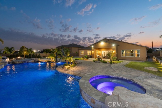 Discover your new lifestyle at Bella Vista in this one-level glorious Rancho Cucamonga home with enormous cascading waterfall pool & unforgettable 270-degree panoramic city light & mountain views!  Arrive at this cul-de-sac with over ½ acre yard complete with stylish pavers throughout the backyard then step inside this bright modern & cozy newer construction home. You will want to linger in the dramatic open living room while modern clean colors, chic luxury vinyl floors and high ceiling with recessed lighting wraps its arms around you with a contemporary but warm feel.  Prepare feasts with ultimate upgraded GE café appliances in this generous Chef s kitchen with extra-large granite island & custom large walk-in pantry complete with marble counter & built-ins. The large private backyard is like a 5-star resort and invites you to relax & entertain with 16 ft California bi-fold doors to bring the outside in.  The covered patio is complete with cozy fireplace for those cooler nights, & I can t even start to explain the pool, waterfalls, slide, grotto, ambience lighting, 44,000 gallons with no expense spared.  Enjoy your favorite music with 8 Jamo speakers to keep those parties going. Don t forget the large custom shed on concrete foundation to keep all your holiday decorations.  You will want to sit in your spa or around the firepit and enjoy your views all year.  Perfect entertainers  backyard. House is perfection down to car-buff s custom garage red & black tile flooring, wall-mounted storage cabinets & above-head storage with LED lighting, 2 - 50 Amp 220 outlets for your electric cars or welders on each wall along with extra outlets including a 30 amp outlet.  The 9KW SOLAR is fully paid off & keeps your pocket full by covering your monthly needs. RV parking/5-car wide driveway/built-in cabinets w marble countertops/floating shelves/rain gutters, custom baseboards, crown molding/frameless shower luxurious large bathtub in en-suite master bedroom/ multiple custom barn doors/ modern farmhouse style/Jack & Jill bath between two additional bedroom w double sinks /media room w 7-1 surround sound & 115 screen.  Custom mother-in-law quarters with built-in cabinets w marble tops/refrigerator/handicapped upgraded walk-in shower. Convenient office off garage for privacy. Smart switches electrical & complete Nest & Kuna camera security cover entire home. Close to Victoria Gardens, 15, 210 fwy/ award-winning Etiwanda school district. Furniture Negotiable.