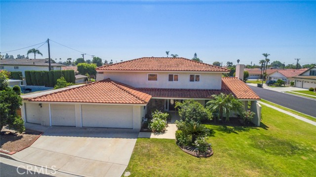 Located in the highly desirable Charloma Estates on the corner of a quiet cul-de-sac, this home offers 4 bedrooms and 3 full bathrooms in a spacious 3,168 square feet. On the first level there is an updated kitchen and bathroom, a formal dining room, living room, family room, sitting room, a large laundry room with storage, and an expansive bonus room that s use is only limited by one s imagination. Upstairs you will find the primary bedroom with en-suite bathroom and walk-in closet, a second bathroom, and 3 additional bedrooms. The 3-car attached garage plus another separate single car attached garage allows for all of your vehicles, toys, and extra storage. There is also a work shop space and built-in floor hoist in the garage. The backyard has block walls giving it privacy. This home is close to freeways, shopping, parks, and schools.
