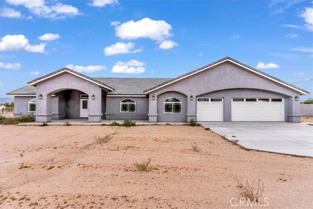 BRAND NEW HOME IN HESPERIA, CLOSE TO RANCHERO AVE. THIS HOUSE FEATURES 4 BEDROOMS 2 FULL BATHS AND A 3/4 BATH. IT HAS 2,660 Sq. Ft OF LIVING AREA AND ALSO THERE IS A LARGE SIZE WORKSHOP IN THE BACK 30 Ft X 80 Ft FOR A TOTAL OF 2,400 Sq. Ft AND 14 Ft HIGH THAT CAN BE USED AS STORAGE, WORKSHOP, OR WHATEVER YOU DESIRE, STRONG AND BUILT TO LAST. THE HOUSE HAS AN OPEN FLOOR PLAN THAT STARTS WITH A DOUBLE FRONT DOOR INTO A LARGE LIVING ROOM THAT HAS A FIREPLACE AND FLOWS INTO THE DINING AREA AND KITCHEN WITH LOTS OF CABINETS, AND AN ISLAND WITH QUARTZ COUNTERTOPS. THIS HOUSE HAS HIGH CEILINGS A WITH RECESSED LIGHTING THROUGHOUT THE HOUSE. IT HAS A WATERPROOF FLOORING ALL THROUGHOUT THE HOME. THE MASTER BEDROOM HAS ITS OWN PRIVATE BATHROOM WITH DUAL SINKS. THREE-CAR ATTACHED GARAGE THAT IS COMPLETELY FINISHED WITH DRYWALL AND THERE IS A TANKLESS WATER HEATER. THE LAUNDRY ROOM IS NEXT TO THE MASTER BEDROOM IN THE HALLWAY. THE LOT SIZE IS OVER AN ACRE WITH PLENTY ROOM TO ENJOY IT.