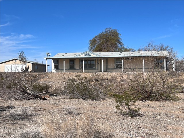 1 ACRE PROPERTY WITH A 1426 SQUARE FOOT HOME AND DETACHED GARAGE!! This property has the potential to be everything you've been looking for! Just minutes from the Colorado River, Endless off-roading trails and Panoramic views!! This spacious 3 bedroom, split floor plan and 2 bathroom home features indoor laundry, living room, kitchen open to dining room and family room, high ceilings and lots of natural light. Master bedroom has a walk-in closet and large bathroom with soaking tub and walk in shower. Covered concrete porch the full length of the home in the front and back. Detached garage has a half bath and workshop area. There's room for ALL your toys here!! With some imagination and some sweat equity, this property is the perfect getaway retreat or forever home! Don't let this one slip by!!