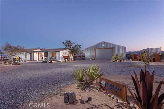Private, sprawling, and genuinely enchanting, LaLa Land Ranch blends the Old West with Bohemian and Modern with Eclectic and tops it all off with an enviable Joshua Tree vibe. Extending approximately 20 acres and surrounded by tranquil mountain and desert views, this high-desert property is the perfect abode for the eccentric host, opportunist, or investor who wants to have it all. Discover an upgraded contemporary main house with three bedrooms and two baths in approximately 1,770 square feet; six classic vintage travel trailers with patio spaces and access to a luxuriously appointed bath and shower house; an outdoor kitchen with BBQ, pizza oven, griddles and a refrigerator; a dining atrium that comfortably seats 65 people indoors; and a hanger/garage/shed, which offers countless opportunities for indoor events in more than 1,800 square feet. An eclectic playground, the property offers unique outdoor dining areas, a raised view deck, covered outdoor patios at the main house, a bocce ball court, and fire pits where friends and family gather to make lasting memories. Only a fraction of LaLa Land s all-flat property is in use, with the rest providing an opportunity to implement more amenities such as rock walls, pickleball, or a pool, to name a few. Existing power and water will ease new construction costs. One of Joshua Tree s best-kept secrets, LaLa Land is just 40 minutes from Palm Springs International Airport and about 130 miles from Los Angeles, making it a convenient lock-and-leave escape for musicians, artists, and others seeking a peaceful getaway near Joshua Tree National Park; or a promising business venture for those who wish to share the magic beyond their closest circle.