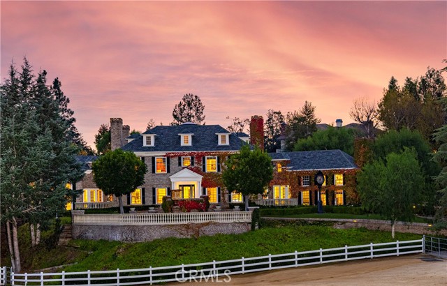 Every element of a true estate property, presented on nearly six acres in the private, exclusive Los Ranchos Estates. Grand and timeless, the main residence, guest house, barn and stables are pristinely articulated, reminiscent of European-Georgian style structures   bearing the hallmarks of exceptional traditional architecture. Enveloped by panoramic mountain, hillside, pasture, and woodland vistas, the completely gated equestrian compound is thoughtfully set amid mature, manicured grounds - enjoying verdant views from every vantage point. A gracious experience upon entry, an expansive tree-lined drive and stone-paved motor court is a mere introduction to the stately primary residence. Impressive in scale and construction, the home encompasses myriad formal and informal living spaces, seven bedrooms, nine baths, an art studio, dance studio, fitness room, media room, an office, service quarters, lounge, library, a subterranean wine room, and a kitchen equipped for entertaining of any style. Generously adorned with the finest finishes, no expense was spared when fashioning appointments   abundant use of exotic hardwoods and stones; coffered wood and medallion metal ceilings; designer fittings, fixtures, hardware, lighting installations, wall and window coverings; professional-grade appliances; custom millwork; six European-style fireplaces; and artisan-crafted architectural details and environmental art pieces create a perfect harmony between luxury and modern domesticity. The serene grounds are splendidly balanced with features to afford relaxation and recreation   tranquil terraces, a sparkling pool and spa, pool pavilion, and outdoor fireplace and living area exist in idyllic seclusion; and the adjacent paddocks, riding arena, and stables with accommodation for six horses, a tack room, office and living quarters are befitting for even the most discerning equestrian. Spectacular detail was bestowed in composing this parcel beyond compare   creating luxuriant, yet comfortable environments across the acreage.