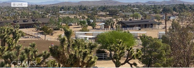 This is a beautiful horse ranch located in the high desert. Close to Joshua Tree and Palm Springs.  2072 sq ft home with 1018 sq ft finished garage, 2689 gross sq ft. Epoxy garage floor with 1/2 bath in garage . 60  x 40  6 stall Castle Brook barn, includes turn out, tack room and 16  breezeway. Barn is equipped with water and power.  7 - 24  x 24  horse pens with 8  x 24  covers in the lower part of the property.  All trees are set up an automatic water. RV hook up includes electrical, water and a dump station. Covered porch in front and back of house with stamped concrete. Back includes a built in BBQ as well as electrical and water. Master bedroom has a spa tub with a walk in all tile shower.  Walk-in closet off master bedroom.  Vaulted ceilings with a bay window and dormers. Living room has a beautiful rock fireplace.  Can lights and ceiling fans throughout house.  Kitchen has granite countertops. Zoned central air and heating, 2 units. This ranch is all set up and ready to move in with 2 arenas and round pen. Bring your animals and toys and come enjoy the beautiful hi desert.