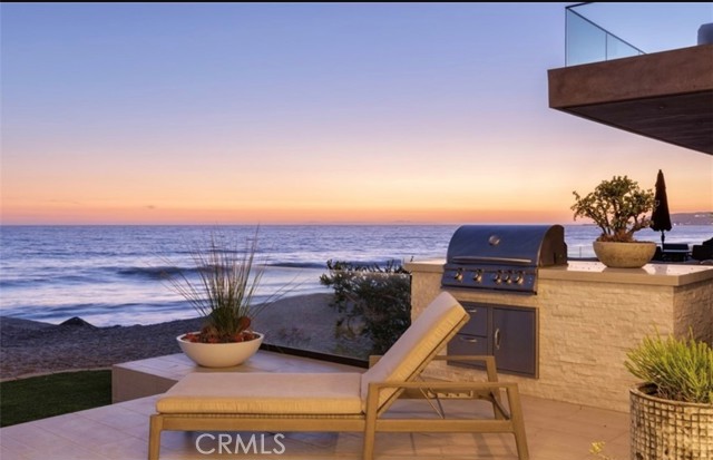 Embrace all that oceanfront living offers in this incredible home on the sand. Immerse yourself in the tranquil serenity of this immaculate property in the exclusive Dana Point Beach Road community. Each space of the over 3700 SF home has been thoughtfully designed to maximize the stellar ocean views and open concept architecture. The gourmet kitchen showcases top-of-the-line appliances and materials while the rest of the home is accented by a blend of rich textures creating a cohesive and luxurious beachfront oasis. The primary suite boasts a spa bath, expansive walk-in closet, and French doors flowing to its own balcony. Each additional bedroom offers its own ensuite and spacious closet. Positioned on a large lot, this home features 4 bedrooms and an open office/library with direct ocean views, making working from home a dream. The coastal chic color palate and muted understated elegance make this property welcoming. This home is in close proximity to Dana Point Harbor for the boating enthusiast, Doheny State Beach (famous surf spot), and excellent schools, shops, and restaurants. This upscale enclave of homes is patrolled and offers both privacy and security. Added features include an amazing rooftop deck with gorgeous views and a hot tub, a private elevator, and a two-car garage with added parking for three.