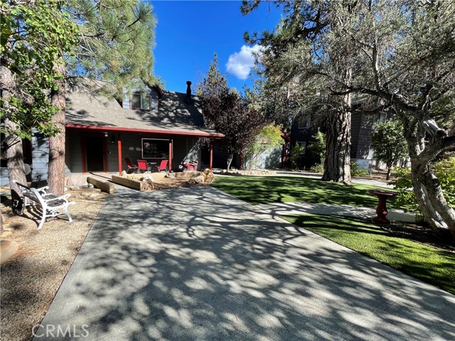 One mile South of Big Bear City, Sugarloaf is an unincorporated area. Beautifully maintained and furnished turnkey mountain home located on a triple wide lot, great for owner occupied, long or short term rentals. Meticulosity landscaped and fenced yard with numerous trees and shrubs watered via automatic sprinkler system. Remodeled kitchen featuring granite countertops, island and fabulous copper sink. Cook top with exterior stove venting. New wood style tile flooring throughout living room, kitchen, dining room and upstairs bath. Retreat like master bath with level entry, oversized shower and rain water style head. Gas feed tankless water heater. One bedroom and bath downstairs, 3 bedrooms upstairs with a power room. Features a wood burning stone hearth fireplace in the living room. Outside amenities included fully fenced yard, above ground heated deluxe hot jacuzzi tub/spa, new stainless steel BBQ connected via natural gas, two storage sheds with loft for extra storage, fire wood, snow toys and two power snow blowers included in sale. Dog run, covered front porch and 2 concrete driveways providing ample off-street parking for 5 vehicles. Mature fruit bearing apple and pear trees. Numerous recreational activities near by including state park, hiking, fishing, biking, skiing and nature trails. Just 10 minutes fro the ski slopes.