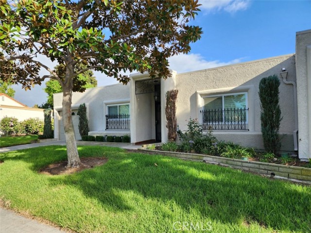 This VILLA FUENTE is A MODEL PERFECT SHOWPLACE in the senior 55+ Laguna Woods Village Community. Located on a single loaded street this home is Private, Peaceful and Perfect! The back side of this home has a large covered patio with a VIEW of the 9 hole golf course! The expanded remodeled gourmet kitchen has quality upgraded cabinets, newer countertops, ceiling light fan, recessed lights, two double paned windows, and the original door to the attached garage was moved to a better location. Laminate type flooring is in the kitchen, dining room, entry and hall. The living room has a sliding glass door with sliding shutters that lead to the back patio. A large skylight has been added to the living room along with can lights. The Master Bedroom has a sliding door with shutters that leads to the back patio. Large mirrored floor to ceiling sliding doors cover the closet. The remodeled master bathroom has double sinks, upgraded vanity and counters and a beautiful large custom shower. The second bedroom has a floor to ceiling large closet, carpet and windows with shutters. The guest bathroom has a remodeled shower. The style and design of this home are unique and offer a pride of ownership. Enjoy the amenities of Laguna Woods Village: 27 and 9 hole golf course, tennis, paddle ball and pickleball courts, 5 swimming pools, 800 seat theater, 7 clubhouses, Gate guarded security 24 hours, large fitness center, gardening center, RV storage, and over 200 clubs and organizations. Gate 10 is minutes away. Laguna Beach, shopping malls, toll roads, Saddleback Hospital, and more are within a short driving distance.