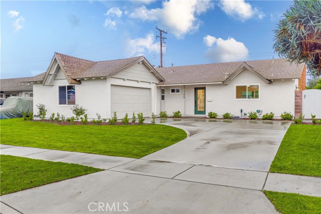 Prepare to fall in love with this completely remodeled single-story home in the heart of Los Alamitos bordering Roosmoor. Overflowing with charming curb appeal, this turn-key home greets you with a trendy foyer shiplap accent wall and a bright open floorplan inside with tons of natural light. Entertain friends and family in the formal living room or the spacious family room area complete with a cozy fireplace. The brand new kitchen opens to both the family & dining areas and boasts quartz countertops, a large breakfast counter, all new stainless steel appliances (5-burner gas range/oven, range hood, dishwasher & microwave), full-height designer tile backsplash, and stylish new shaker cabinets w/ contemporary handles. The dining area even has a separate dry bar/serving station with a beverage cooler, perfect for hosting and the upcoming holidays! The bathrooms have been fully remodeled featuring tile flooring, modern lighting, decor mirrors, designer tiled shower walls and new shaker vanities w/ quartz counters, while the primary bedroom includes a walk-in closet w/ built-in organizers and a barn door to the en-suite bathroom boasting dual sinks & shower heads and a stunning fully-tiled walk-in shower. The home also has been upgraded throughout with all contemporary lighting & fixtures, fresh interior & exterior paint, dual pane windows & sliders, mirrored closet doors and brand new luxury vinyl wood plank flooring. Outside, the considerable wraparound backyard features an extended patio and an expansive new lush lawn - all you could imagine for your outdoor entertainment. This home's convenient location is just minutes away from the Los Alamitos School District s highly-rated & award winning schools and offers easy access to freeways, business centers, shopping, restaurants and more. Come start making long lasting memories!