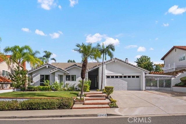 GORGEOUS SINGLE-LEVEL POOL HOME WITH LAKE & MOUNTAIN VIEWS JUST LISTED IN MISSION VIEJO! Located on a single-loaded cul-de-sac street in the highly desirable Madrid del Lago community, this remodeled 4 bedroom, 3 bath custom Santa Teresa model home is move-in ready w/a big 7,410 sqft lot & RV parking potential. A custom Emtek oversized keyless front door w/side privacy glass opens to formal living & dining areas featuring cathedral ceiling & lots of natural light - the original concrete step-up/down at entry has also been conveniently removed for easier access. Large sliding glass doors off living room showcase the backyard and sparkling pool & spa, recently resurfaced, serviced and ready for fun! Fully remodeled eat-in kitchen features custom cabinetry w/soft-close doors, black granite countertops & backsplash, built-in Subzero refrigerator, Wolf 5-burner induction cooktop w/stainless steel exhaust hood, Wolf convection steam oven & built-in microwave oven, Cove soft-wash dishwasher, and large-basin stainless steel sink w/Kohler pull-down faucet. The master bedroom features built-in desk nook, mirrored wardrobe doors and custom en-suite bath w/dual-sink granite vanity & backsplash, modern Kohler fixtures, custom lighting w/illuminated mirrors, beautiful step-in granite shower w/rain dual-shower heads & frameless glass enclosure, and removed side-yard access door for a more private usable space. There are 3 additional bedrooms, a remodeled second guest bathroom tastefully upgraded to match the master, and a permitted third bathroom addition featuring vaulted ceiling, step-in marble shower w/frameless glass doors, separate soaking tub, and dual skylights. Also includes full PEX-A repipe w/oversized 2" lines, Enviro soft water system, Noritz tankless water heater, Kohler Avoir tankless commodes, designer fabric window shades, dual-pane windows, freshly painted exterior & interior, Provenza Maxcare waterproof luxury vinyl flooring, custom black granite gas/wood burning fireplace, and new TESLA 16-panel solar energy system w/Powerwall battery storage, upgraded 225 amp panel and added garage sub-panel for 220v charger. Also includes freshly painted back patio, added concrete barbecue prep area, sturdy concrete tile roof, updated rain gutters, Liftmaster dual side-motor garage door opener w/back-up battery, and non-load bearing interior wall removed for more open floorplan. Lake Mission Viejo membership included, low 1.01% tax rate, low HOA dues & no Mello Roos!