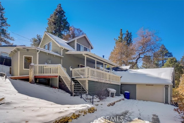 A fantastic family escape after spending the day out on the slopes or just to get away! Enjoy your own creek that runs through the backyard during rainy/winter months and this great home sits on 9 lots which add up to over a half acre, stretching from quiet street to quiet street, and the streets get fully plowed by the city when it snows so the street is always clear! Also, just a short hop to the national forest hiking and biking trails.  This 4 bed/3 bath home features a fully gated property with separate RV/boat/toy access on the backside of the property along with plenty of driveway parking in the front leading up to your attached garage. Enter into the Great Room with vaulted ceiling, recessed lighting, wood panel walls, and a wood-burning fireplace on a raised hearth to complement the central forced air heating. The kitchen is just off of the Great Room and has wood cabinetry with tons of storage space, granite counters, and opens to the laundry room. There are 3 bedrooms on the 1st floor, all with ceiling fans, and the 3rd bedroom has a private bathroom, there is also a full-size hall bathroom for the secondary bedrooms and guests to share.  Enjoy privacy in the primary suite which takes up the entire second floor featuring a large private bathroom with jetted soaking tub/shower combo and a walk-in closet. There is also a welcoming deck to enjoy the views as well as a covered front porch area! Located not far from restaurants, ski resorts, Big Bear Lake, and more!