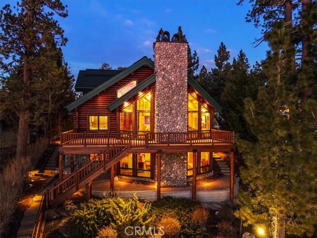 Come see the breathtaking sunsets from this west facing, deep water, Lindley built custom true log lakefront estate on one of the most beautiful locations on all of Big Bear Lake. You'll appreciate the superior craftmanship put into this spacious lodge-style home. With a great room featuring vaulted, open-beamed ceilings, lodge style stone fireplace and amazing views, a roomy loft area overlooking the great room, an expansive downstairs family room, and a huge outdoor deck overlooking the lake, there's plenty of room for entertaining friends and family alike. A well appointed kitchen offers Viking stainless appliances and granite counters opening to the adjoining dining area with lake views. The downstairs family room features a wet bar, billiards, another lodge style fireplace, TV viewing area, and even more great views of Big Bear Lake. The spacious outdoor deck features a panoramic west facing look from Metcalf Bay all the way to Garstin Island and the Big Bear Dam and offers some of the best sunsets in town. On the waterfront, you'll find a two-slip boat dock with boat lifts in a prime, deep water location for convenient lake access. A spacious three car true log garage fits not only your vehicles but has room for all your mountain toys as well. Lastly, a gated entry offers a secluded, private feel for your mountain getaway. Come see Big Bear lakefront living at its finest!
