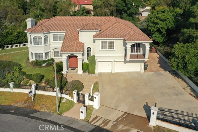 You will notice that this home is located in the most prestigious area of Walnut, Emerald Hills!! This home was custom built and it has a myriad of amenities and features, from its impressive vista as you drive up to it, and the quality of the surrounding neighborhood, to the details of its interior. The home greets you with a double door entry that leads into a marble floored foyer with a one-of-a-kind amazing crystal chandelier. The floor plan then flows to a step-down formal living room and piano area that are also lit by three other striking chandeliers. The home also has a formal and elegant dining room, a great kitchen with granite countertops and a sub-zero built-in refrigerator, a gorgeous permitted sun room which adds an additional 250 sq. ft. (on top of the 5,576 original square footage), a spacious family room, perfect for gatherings, parties or pool days. -- Relax, as you enjoy the beautiful, newly updated and refreshing pool and spa, outside BBQ and new outdoor deck.  --  You can oversee these beautiful grounds directly from, the dinning room, the kitchen, the family room or the sun- room. -- The downstairs guest bedroom has its own bathroom and is tucked away so that it's still part of the first-floor plan yet separate enough to have its own privacy. -- Both floors showcase big windows and 10-foot ceilings (or higher in some areas) that introduce plenty of natural light into this spacious home. --  The upstairs floor has a large landing and common areas, a formal library/office and four bedrooms. The stunning master bedroom is sure to amaze you with its own living area, fireplace, large bathroom with a jacuzzi tub and a huge walk-in closet, and balconies with a view. The upstairs floor plan also includes another one of the bedrooms with its own bathroom. --  The home also includes a gazebo, a three-car garage and a spacious driveway with an additional 7 more car spaces and RV parking. -- The home is located within the award-winning Walnut School district and is walking distance to the local middle school and high school and to many walking and hiking trials that wind through the area. -- Welcome to this beautiful and prestigious property. -- Let s make this your next home!