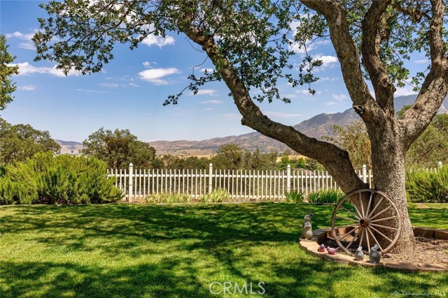 If you appreciate quality, attention to detail and extraordinary craftsmanship, this is THE perfect home for you. Located on 5 acres in the country town of Tehachapi and hidden by more than 150 Oak trees sits  Grand Oak Manor. The grandeur of this hotel-like 6261 sqft home, inclusive of a detached 40 x 60 (2400 sqft) car enthusiast garage & workshop, with its own laundry & bathroom, is the most luxurious estate you will find in Kern County. This stunning property was designed and built by a custom home builder for himself and his family in 2007. Boasting every bit of luxury you can dream up, your mouth will drop just opening the gigantic etched glass front doors. Greeted by a gorgeous foyer, a double door office and a spiraling wooden staircase, your senses delight as you wander into this luxurious mansion. Twenty foot ceilings tower over a floor to ceiling fireplace and artistic mural masterpieces cover the upper walls to keep your guests looking toward the skies in this enormous family room. Watch all the best movies on the built in designer home theater surround sound system and entertainment center. Equipped with two islands, Viking appliances, a 48 inch, 6 burner gas cooktop and grille, double ovens, knotty alder cabinets, ogee edge granite countertops and full backsplash, that would impress even the most discerning of chefs. Serve formal dinners in the luxury dining room surrounded by wainscoting, ambient lighting and sophisticated space for your dining table. The warm wooden detail, lush carpeting, brick and cobblestone accents, dual pane windows and custom lighting throughout this estate are unlike anything you have ever experienced. The master has its own wing of the home with a remote controlled fireplace, heated jacuzzi tub and walk-in marble shower, it's own AC unit and sliding doors to your outdoor patio, offering ultimate privacy.  The inviting entertainment lounge upstairs overlooking the family room has a complete wraparound bar, wine fridge, mini fridge, a sink and dishwasher is immediately ready for your events.  This majestic property is home to the valley's wildlife, such as deer, Elk, and birds of every color that wander through your property and create the most beautiful natural wonder land you will ever find. It s zoned for horses so bring your stallions or just bring the horses under the hood of your car collection.