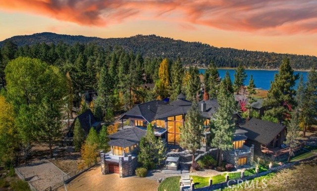 A LUXURIOUS LAKEFRONT HOME WITH AN EXQUISITE LODGE FEEL ~ THIS CUSTOM HOME WAS BUILT BY A LOCAL PREMIER BUILDER WITH SO MUCH VISION ~ OFFERING 6 BDMS~3 FULL BATHS, EACH W/ SOAKING TUBS, TWO 1/2 BATHS ~ 6,750 SQ FT OF LIVING SPACE ~ 1/3 OF AN ACRE OF LAND ~ 180' OF WATERFRONT ~ 35 FT SOARING CEILINGS IN THE GREAT ROOM ~ FLOOR TO CEILING WINDOWS WITH STUNNING LAKE AND MOUNTAIN VIEWS ~ FLOOR TO CEILING WOOD BURNING FIREPLACE ~ GOURMET KITCHEN W/2 FIREPLACES ~ VIKING RANGE & OVENS ~ BUILT-IN REFRIGERATORS ~ PANTRY ~ DINING & PREP ISLAND ~ GORGEOUS STONE AND HARDWOOD FLOORING THROUGHOUT THE HOME ~ 35' CEILING GREAT ROOM ~ MASTER SUITE OFFER EXQUISITE DESIGN WITH THE BEAUTY OF WOOD, METALAND TILE ~ 2-CAR GARAGE + SEPARATE BOAT/STORAGE GARAGE ~ CUSTOM CANOPY DOCK W/SLIPS FOR 1 BOAT AND 2 PWC'S ~ RECENTLY UPDATED HOME THEATRE THAT INCLUDES 8 THEATRE SEATS AND A FEW OVERSIZED BEAN BAGS ~ OUTDOOR SPA W/AUTOMATED GAZEBO COVER ~ BUILT IN BBQ ~ EXERCISE ROOM WITH LAKE VIEWS ~ A MUST SEE!